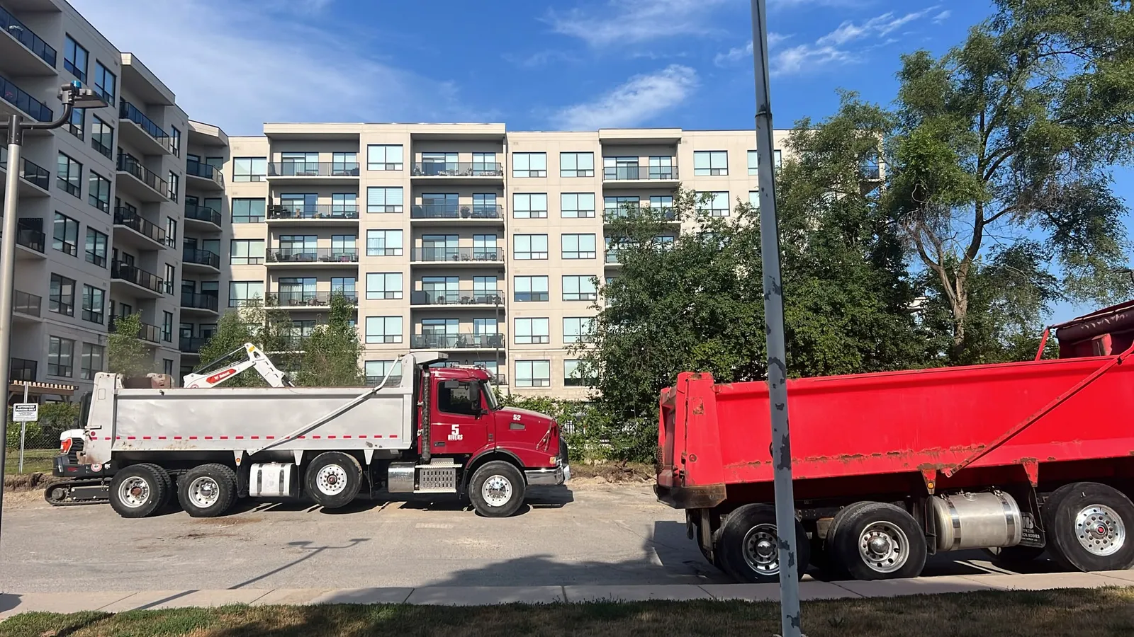 5Rivers Trucking dump truck Unit 52 loading aggregate at a job site