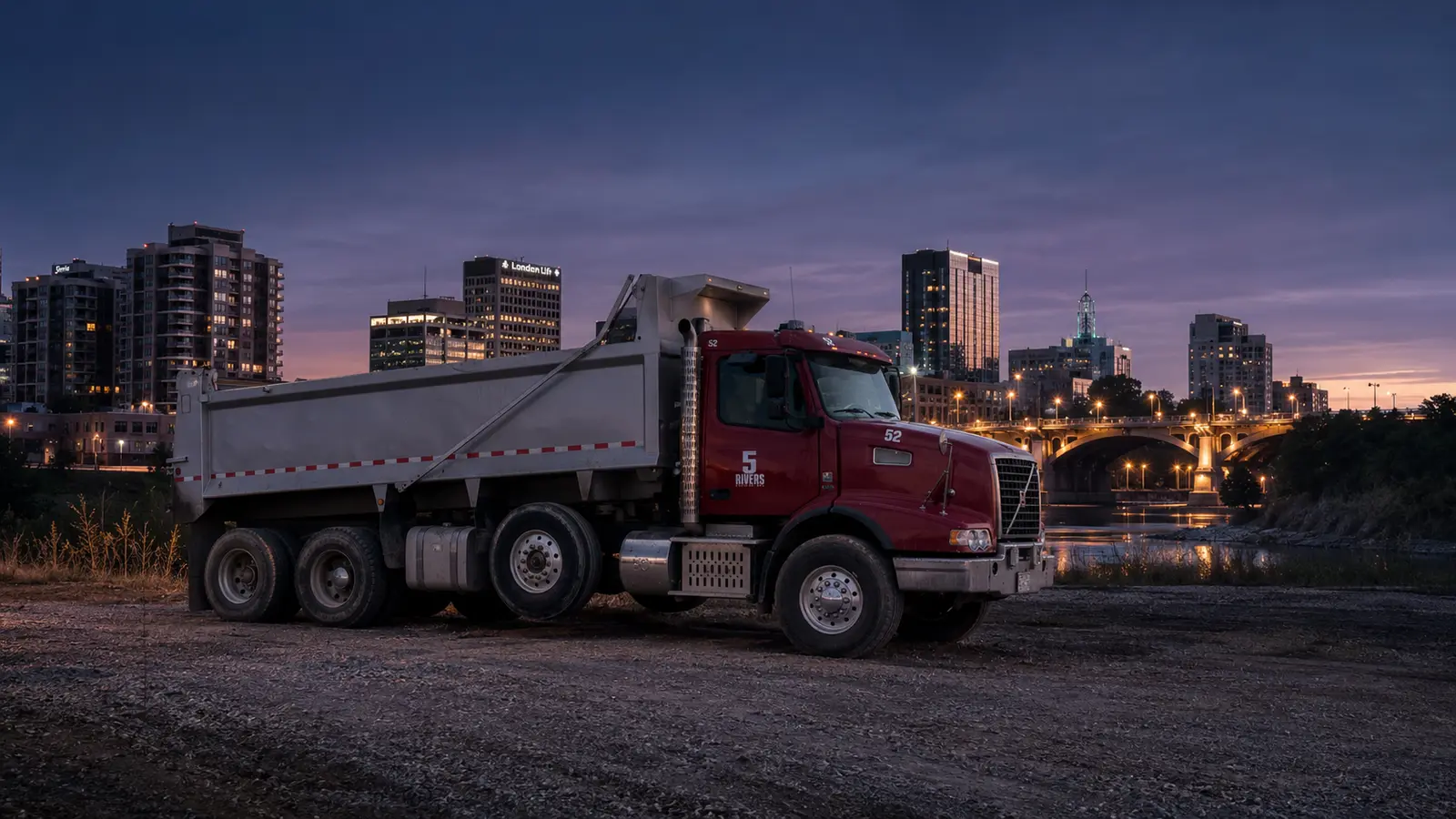 5Rivers dump truck at dusk, London Ontario skyline behind